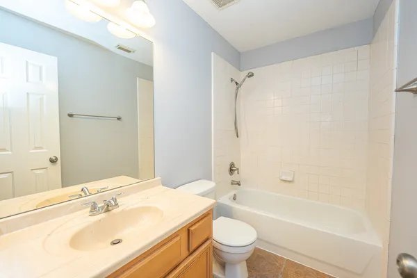 a bathroom with a sink mirror toilet and bathtub
