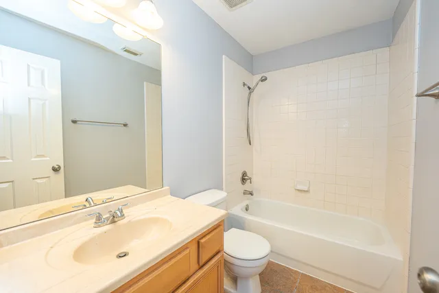 a bathroom with a sink mirror toilet and bathtub