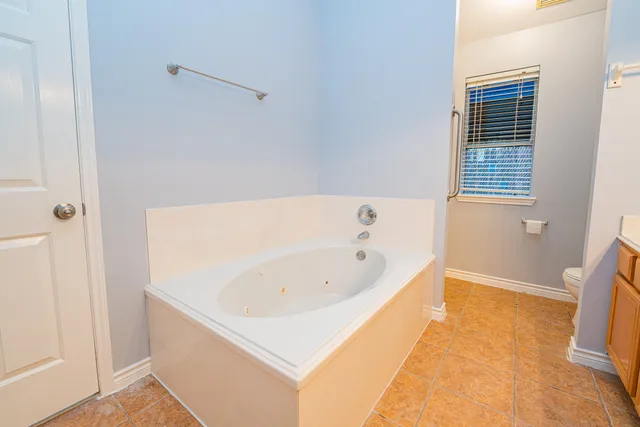 a bathroom with a bathtub and shower