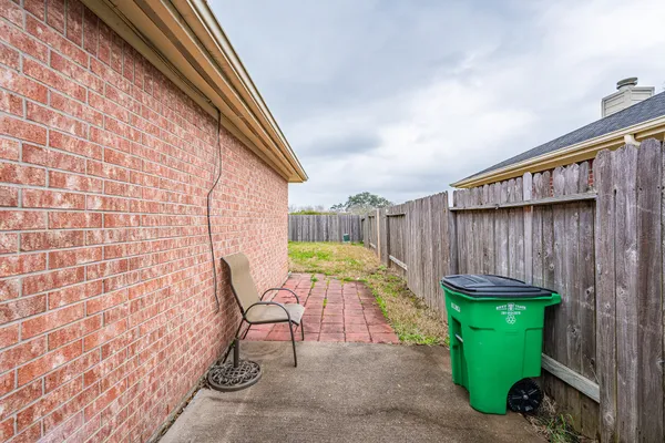 a view of a backyard with chair and table
