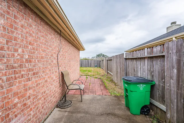 a view of a backyard with chair and table
