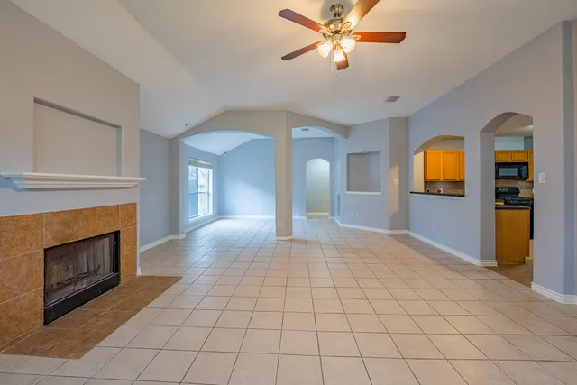 a view of a livingroom with a fireplace cabinet and a fireplace