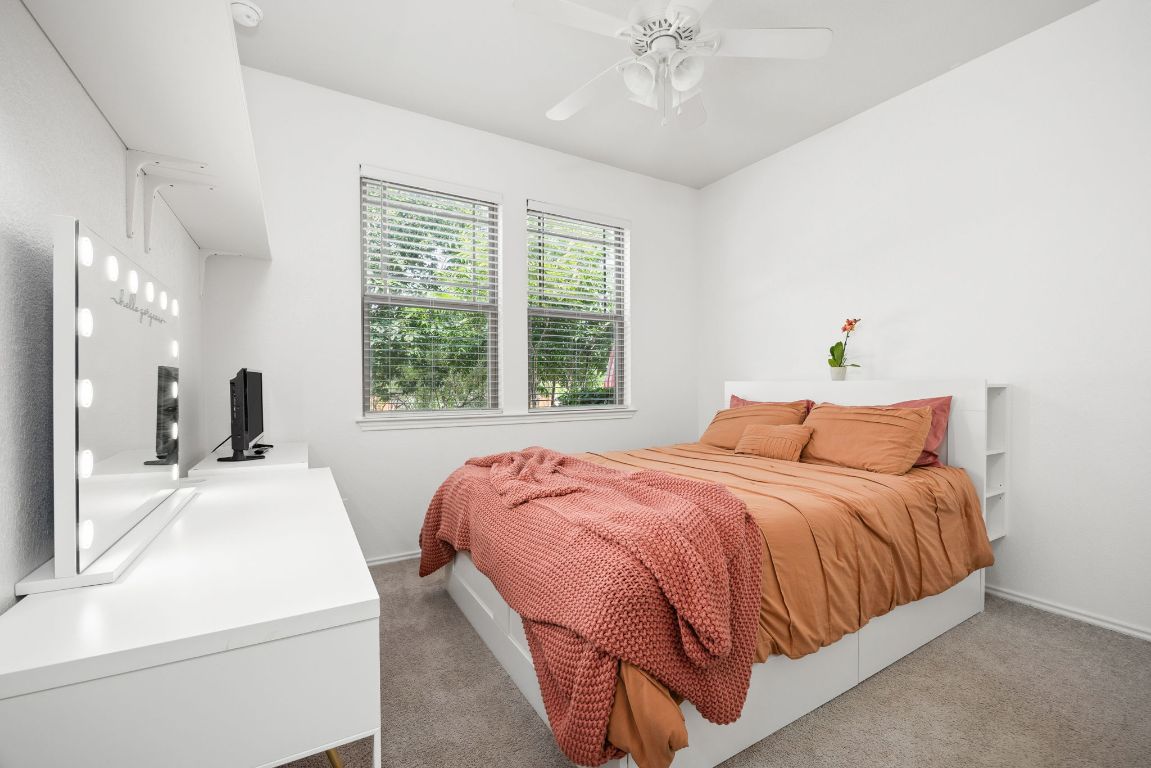 1340 Terrace View Drive Georgetown, TX 78628 - Photo 13 of 25 a bedroom with a bed and a chandelier