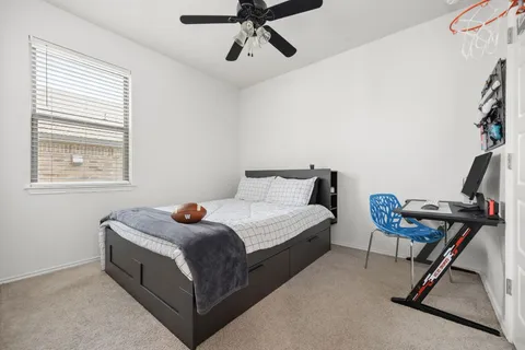 a bedroom with a bed and chair