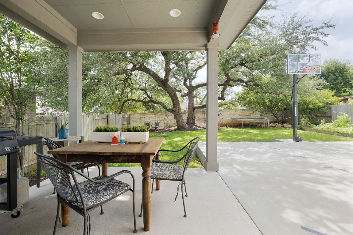 1340 Terrace View Drive Georgetown, TX 78628 - Photo 17 of 25 a view of a patio with a table chairs and a floor to ceiling window