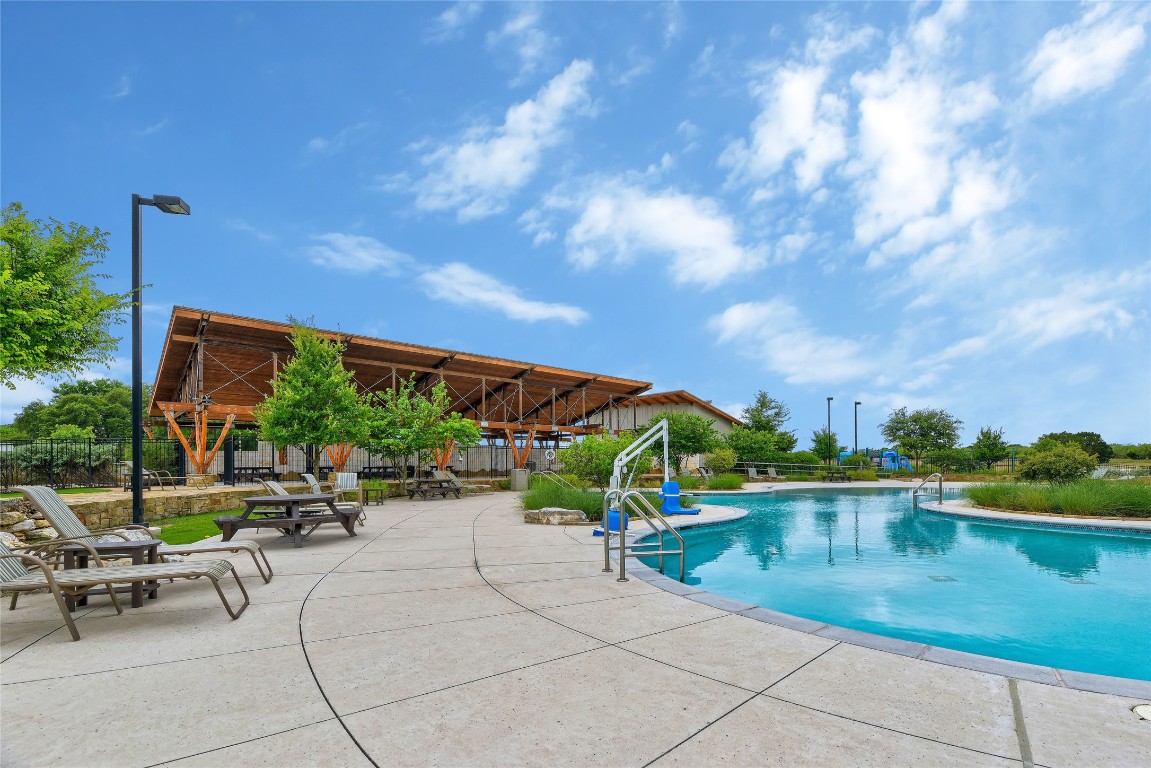 1340 Terrace View Drive Georgetown, TX 78628 - Photo 23 of 25 a view of swimming pool with seating area and trees in the background