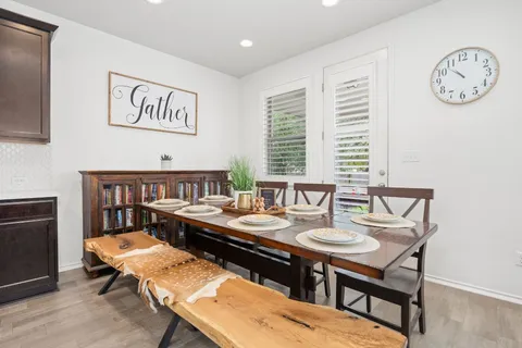 a dining room with furniture and window