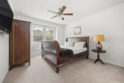 a spacious bedroom with a bed and a chandelier