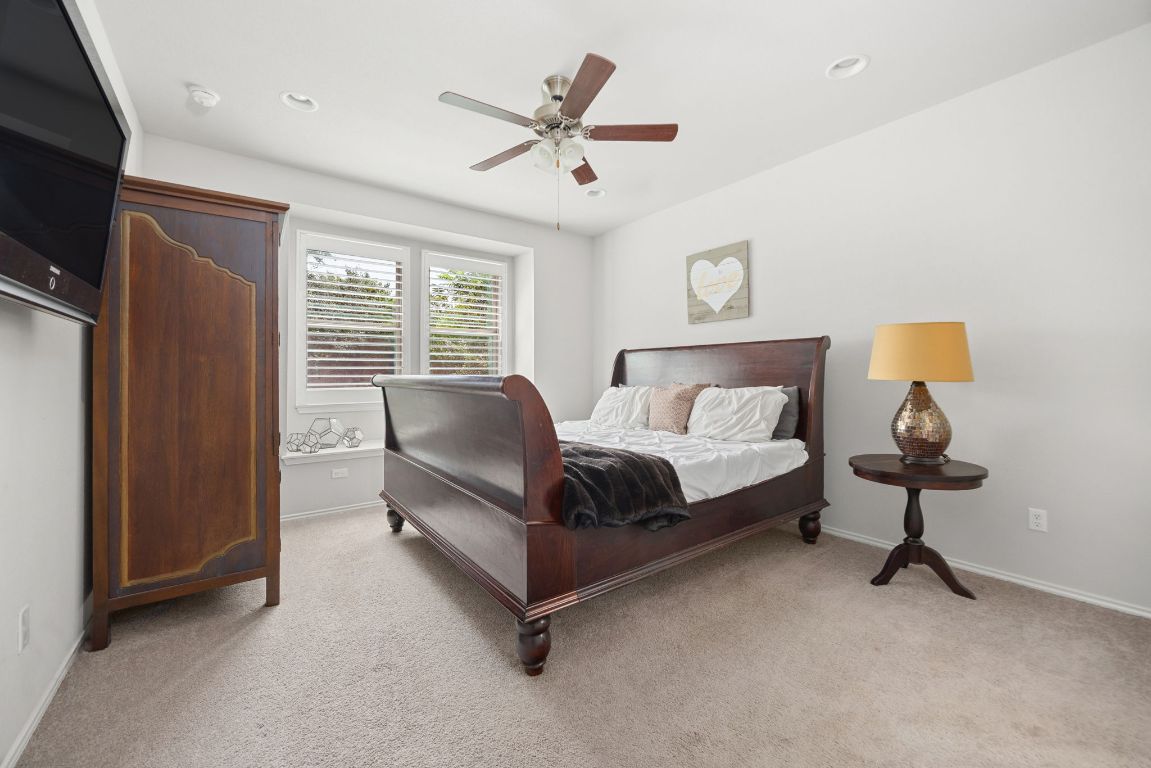 1340 Terrace View Drive Georgetown, TX 78628 - Photo 8 of 25 a spacious bedroom with a bed and a chandelier