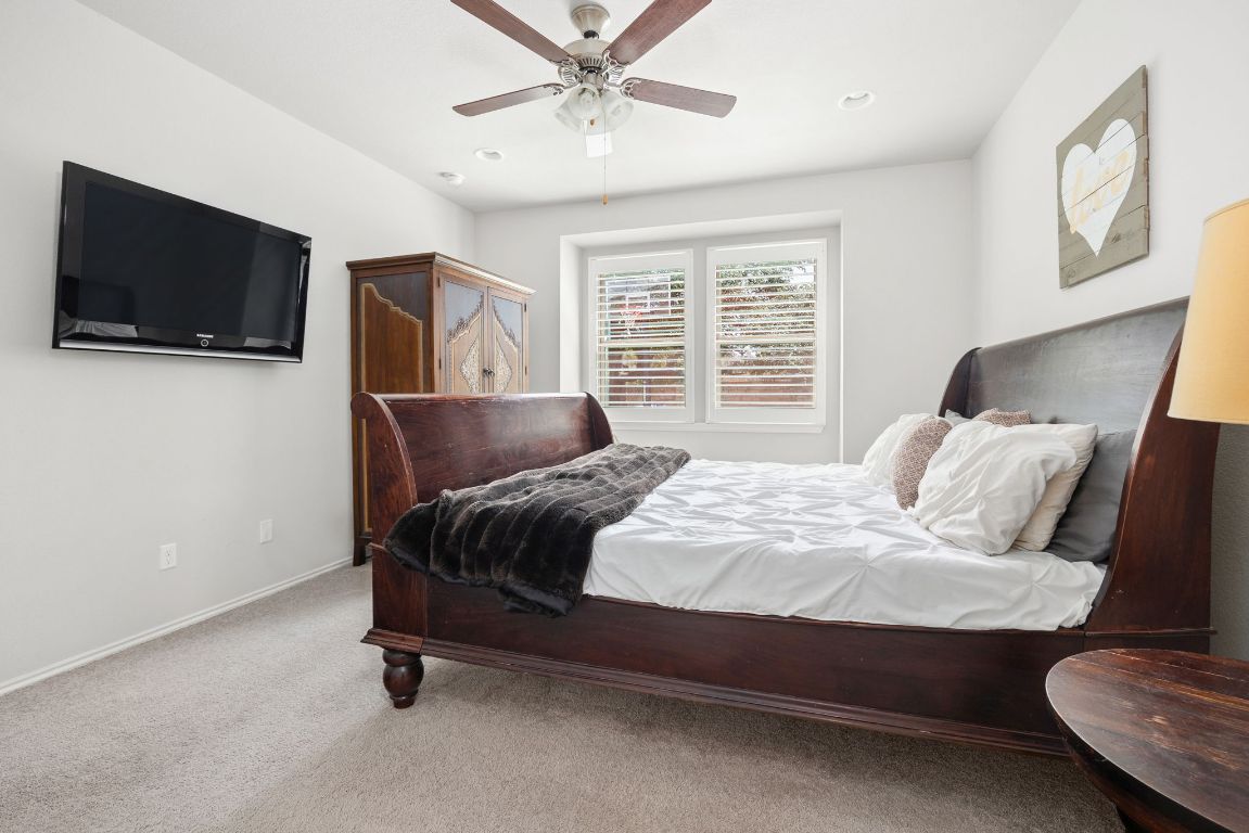1340 Terrace View Drive Georgetown, TX 78628 - Photo 9 of 25 a bedroom with a bed flat screen tv and couches