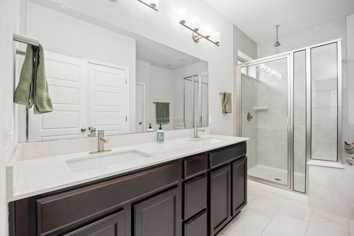1340 Terrace View Drive Georgetown, TX 78628 - Photo 10 of 25 a bathroom with a double vanity sink mirror and shower