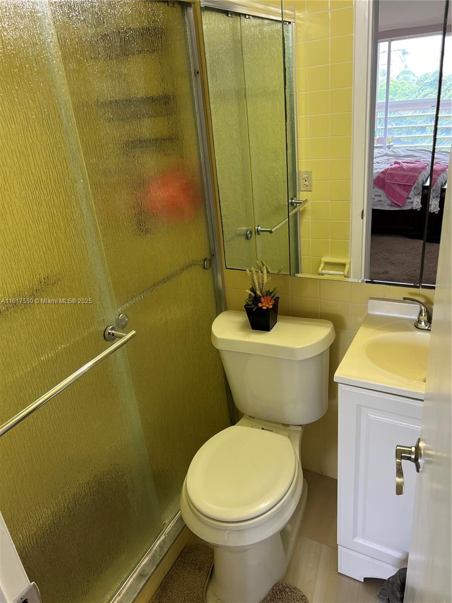 155 Suffolk F, Unit D Boca Raton, FL 33434 - Photo 13 of 41 a bathroom with a sink and toilet