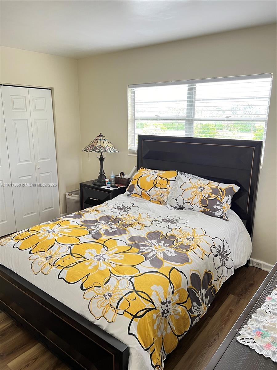 155 Suffolk F, Unit D Boca Raton, FL 33434 - Photo 15 of 41 a bedroom with a bed and dresser