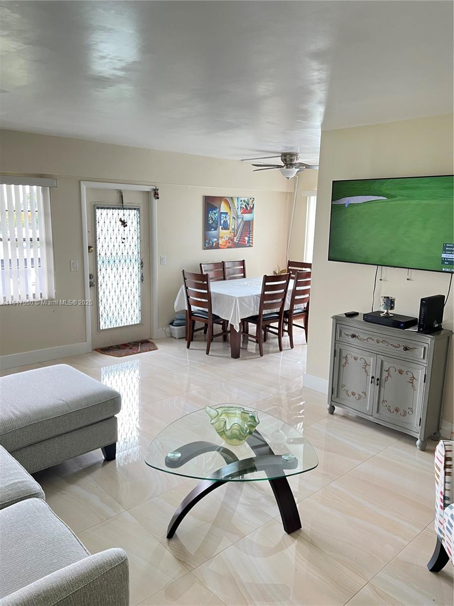 155 Suffolk F, Unit D Boca Raton, FL 33434 - Photo 3 of 41 a living room with furniture a flat screen tv and a window