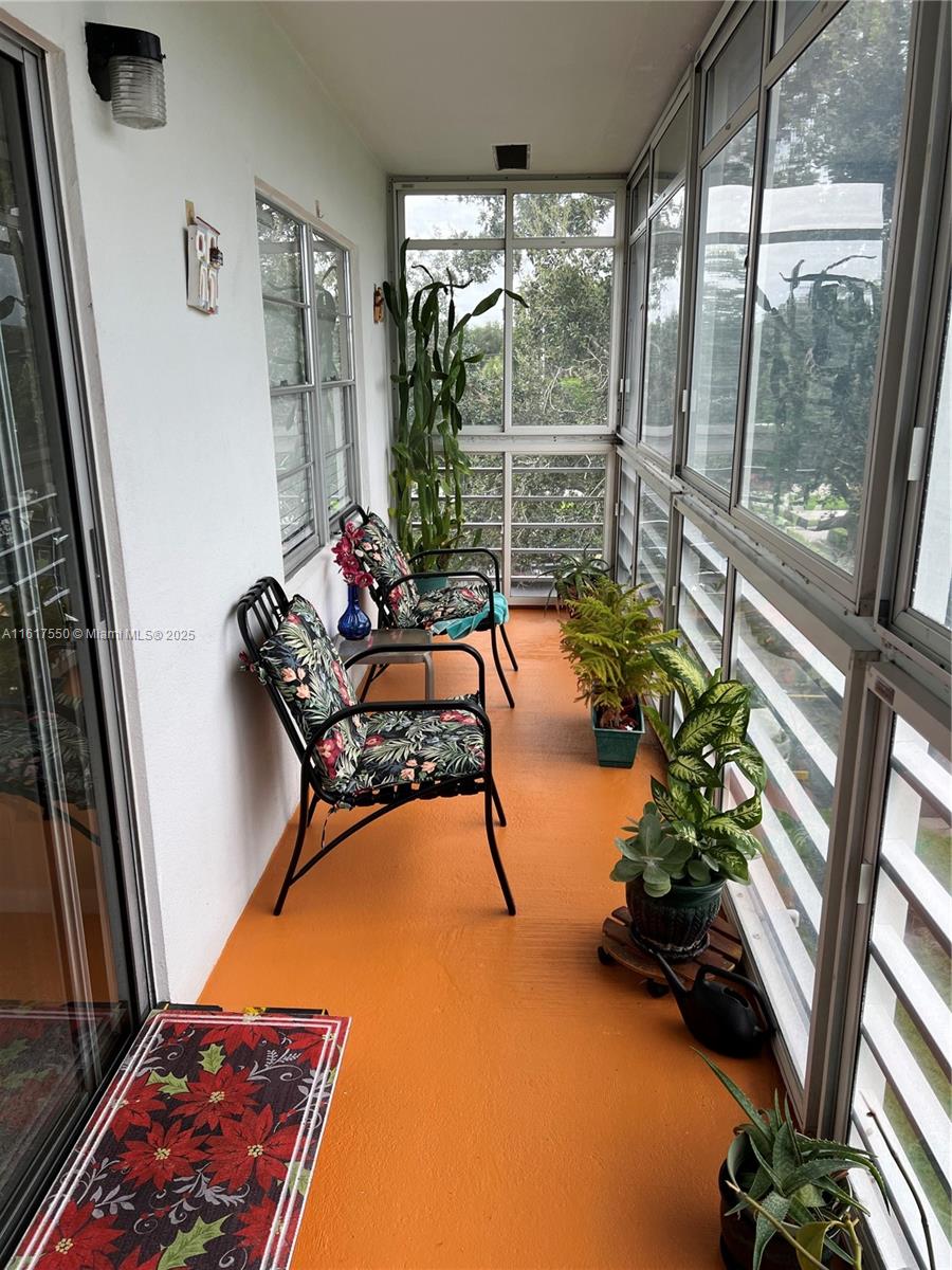 155 Suffolk F, Unit D Boca Raton, FL 33434 - Photo 32 of 41 a room with gym equipment and a large window