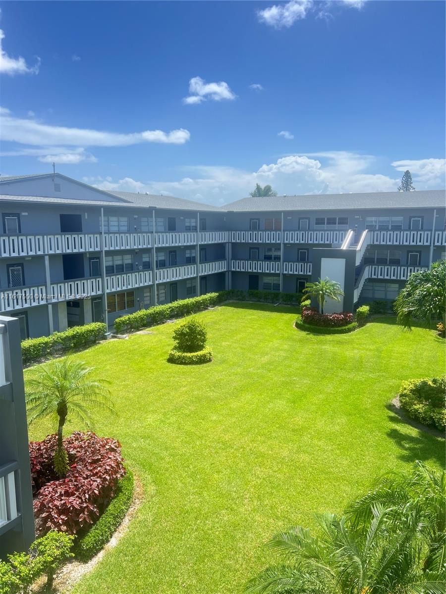 155 Suffolk F, Unit D Boca Raton, FL 33434 - Photo 36 of 41 a swimming pool with outdoor seating and yard