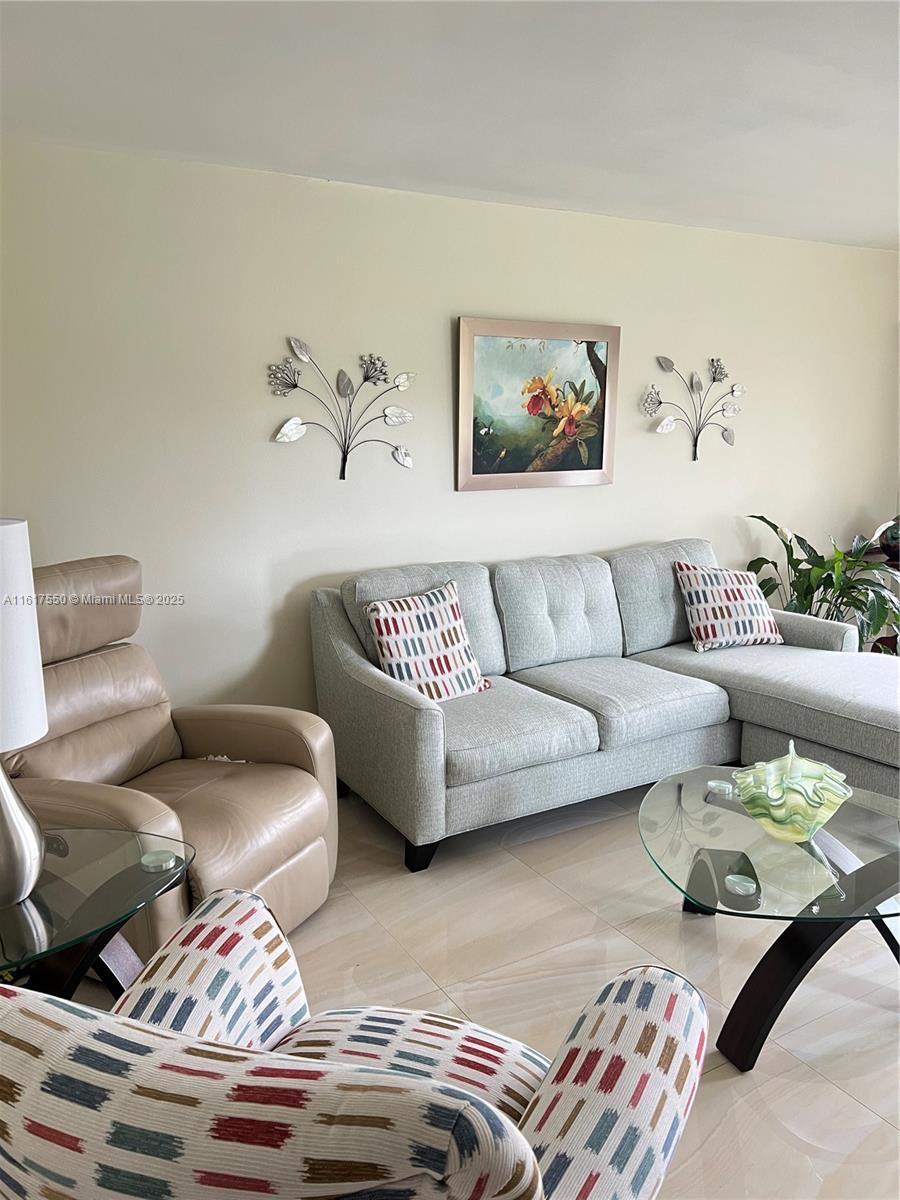 155 Suffolk F, Unit D Boca Raton, FL 33434 - Photo 7 of 41 a living room with furniture and painting on the wall