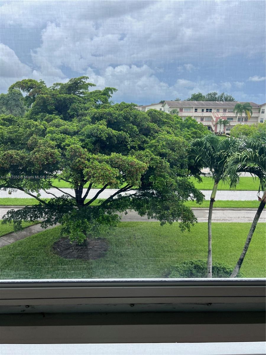 155 Suffolk F, Unit D Boca Raton, FL 33434 - Photo 10 of 41 a view of a yard from a window