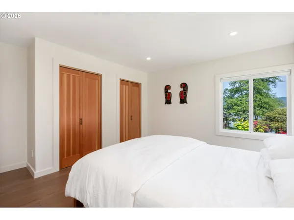 a spacious bedroom with a bed and a window
