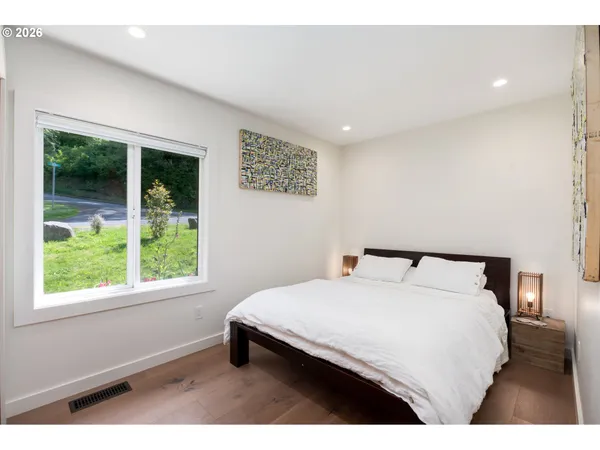 a bedroom with a bed and a window
