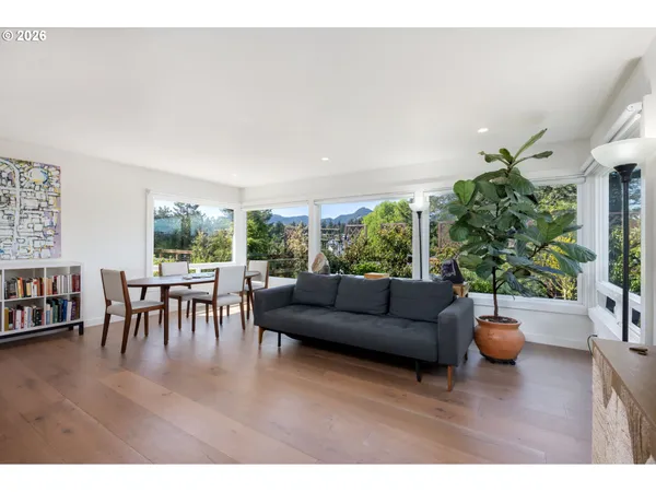 a living room with furniture and a potted plant