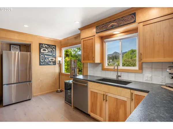 a kitchen with stainless steel appliances granite countertop a refrigerator and a sink