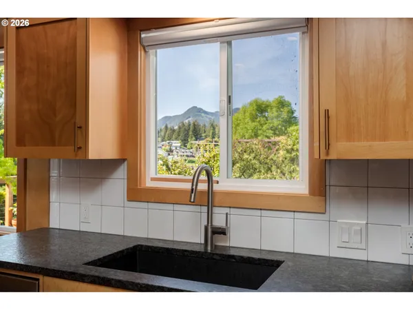 a kitchen with sink and large window