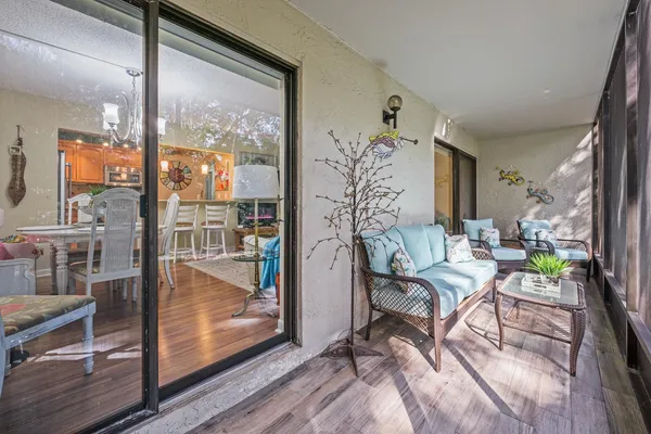 a living room with furniture and a floor to ceiling window