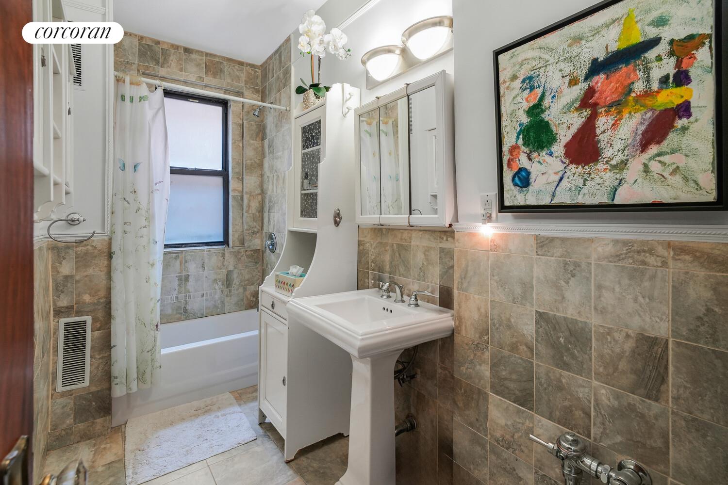 875 West 181st Street, Unit 4L Manhattan, NY 10033 - Photo 10 of 18 a bathroom with a sink a toilet and shower