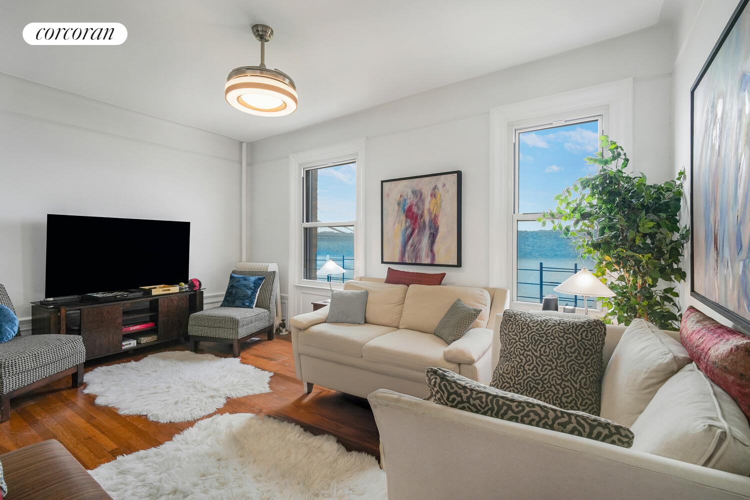 875 West 181st Street, Unit 4L Manhattan, NY 10033 - Photo 2 of 18 a living room with furniture and a flat screen tv