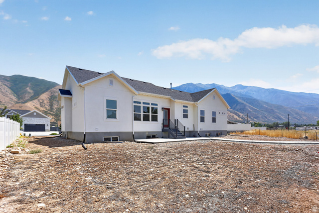 1257 North 1350th Street East Mapleton, UT 84664 - Photo 23 of 31 Contemporary ranch-style exterior with white stucco siding and dark gray roof shingles