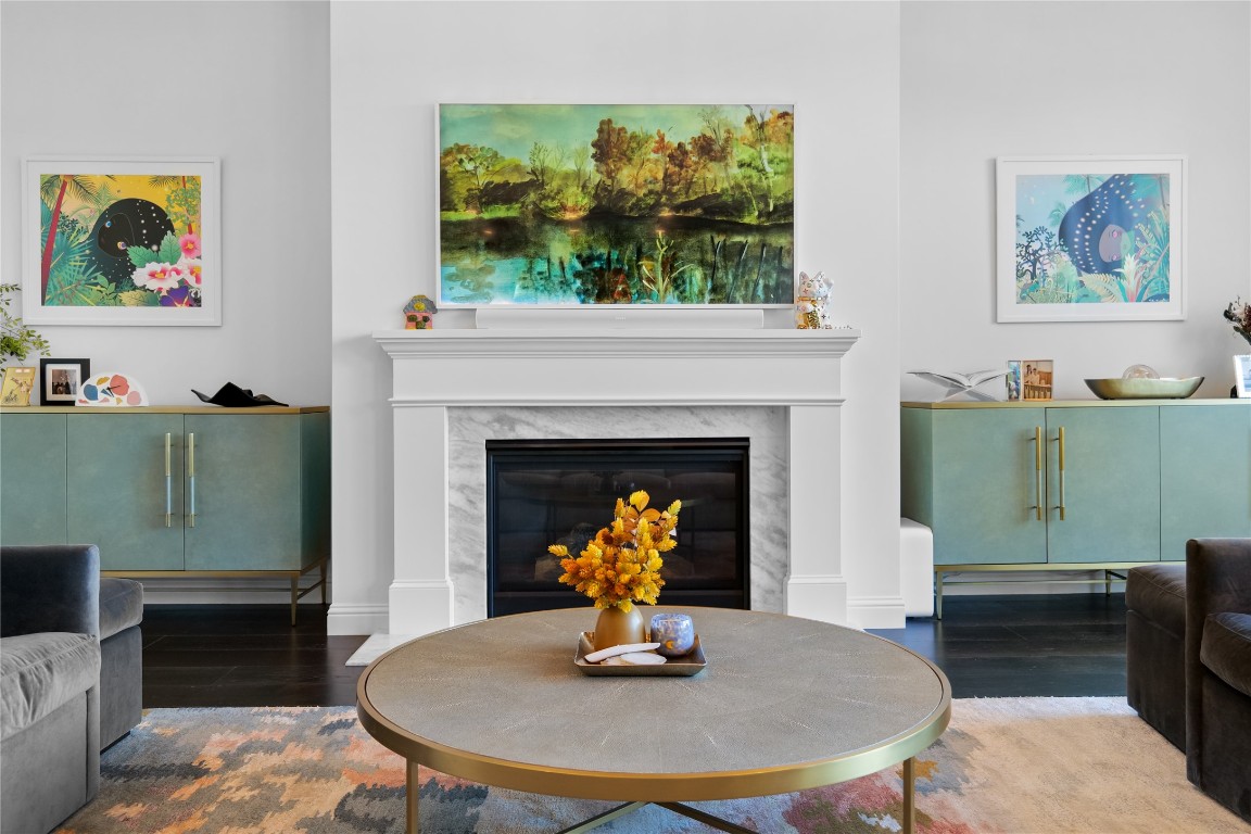 Living area with a high end fireplace and wood finished floors
