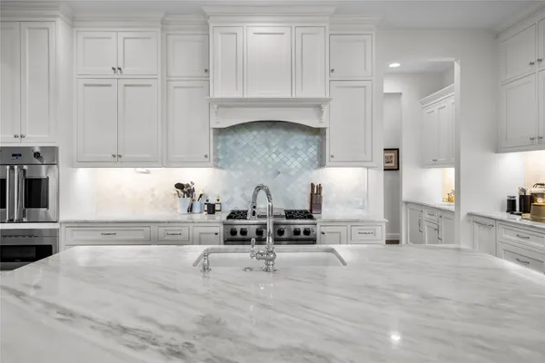a stove top oven sitting inside of a kitchen