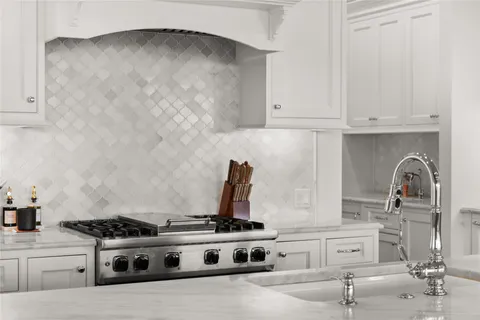 a kitchen with stainless steel appliances granite countertop a sink refrigerator and cabinets