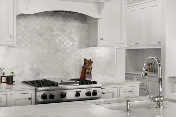 a kitchen with stainless steel appliances granite countertop a sink refrigerator and cabinets