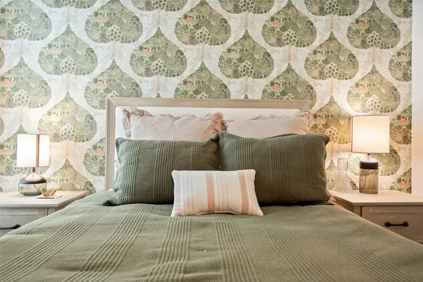 a bedroom with a bed and a chandelier