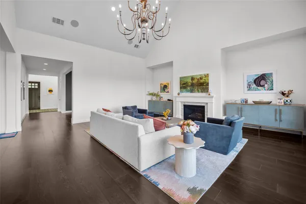a living room with furniture a fireplace and a floor to ceiling window