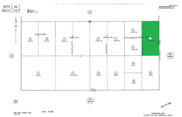 a picture of a room with a white wall and white refrigerator