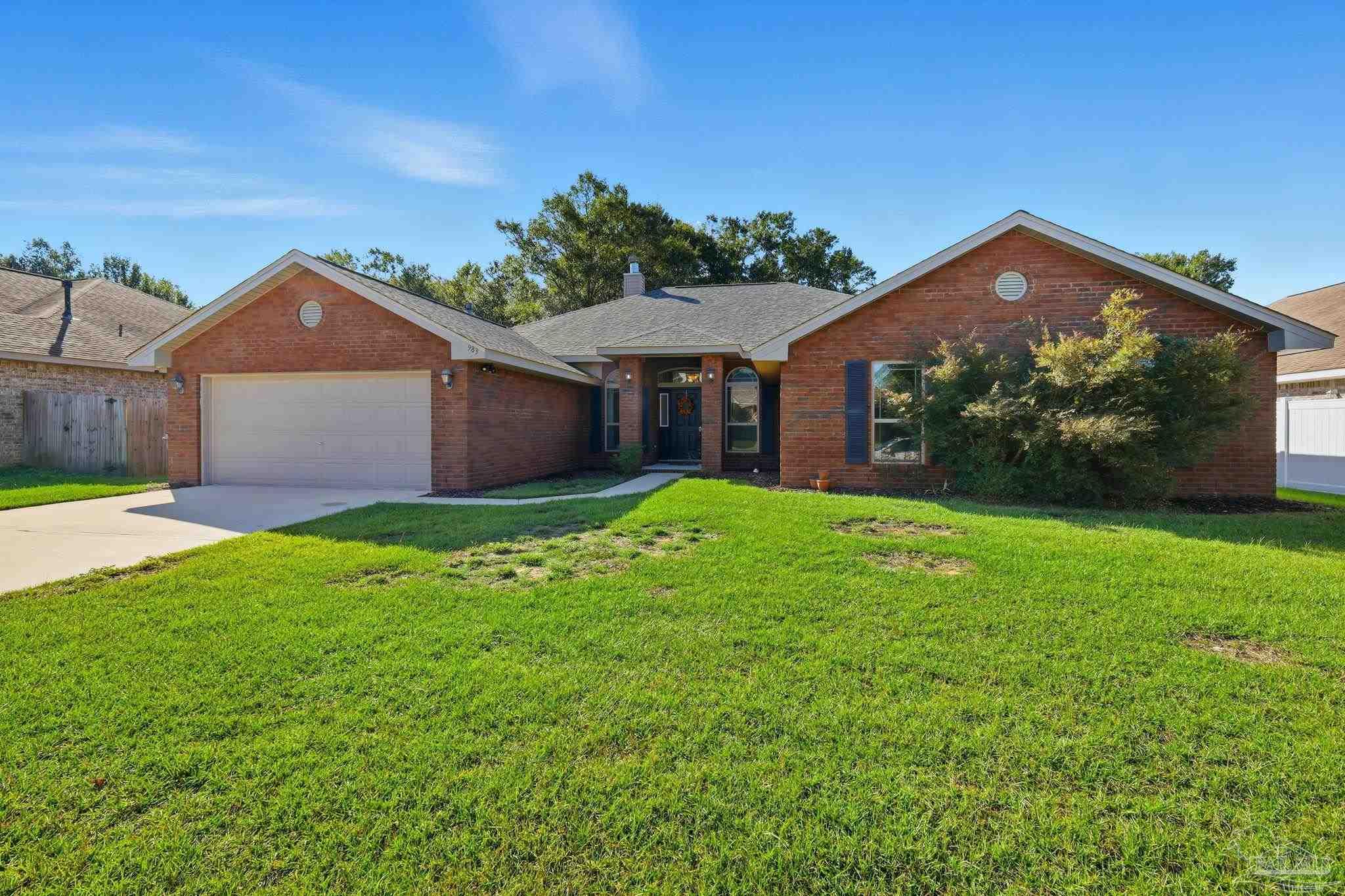 983 Perdido Road Cantonment, FL 32533 - Photo 1 of 1 a front view of a house with garden