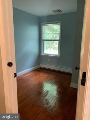9 New Freedom Road Medford, NJ 08055 - Photo 5 of 9 an empty room with wooden floor and windows
