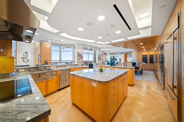 a large kitchen with stainless steel appliances granite countertop a sink and counter space