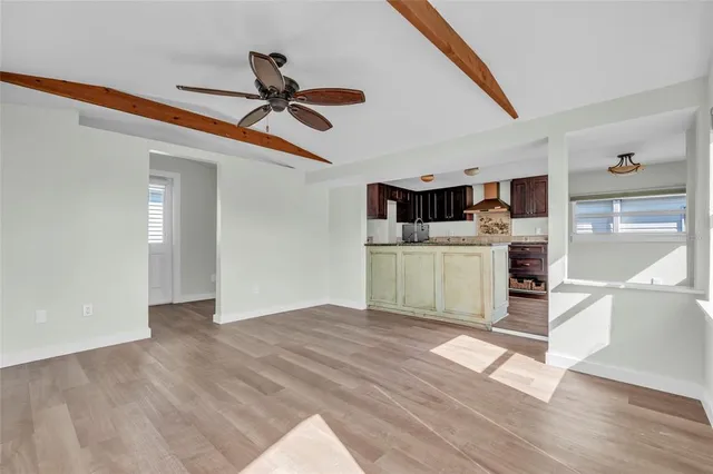 a view of a livingroom with a kitchen and a stove top oven