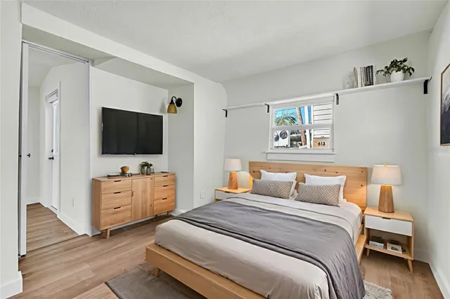 a bedroom with a bed and a flat screen tv