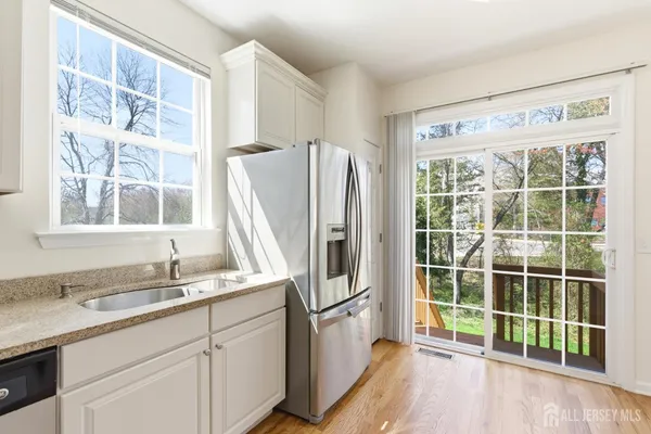 a kitchen with stainless steel appliances a sink and a large window