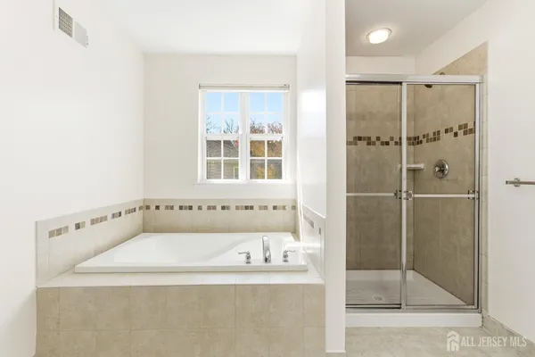 a bathroom with a tub and shower