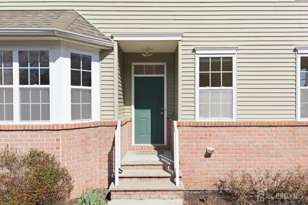 a view of a brick house with large windows