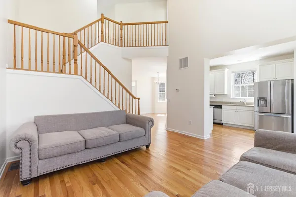 a living room with furniture and wooden floor