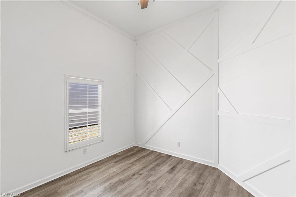 7867 Gardner Drive Naples, FL 34109 - Photo 19 of 36 Empty room featuring light wood-type flooring, ornamental molding, and a ceiling fan