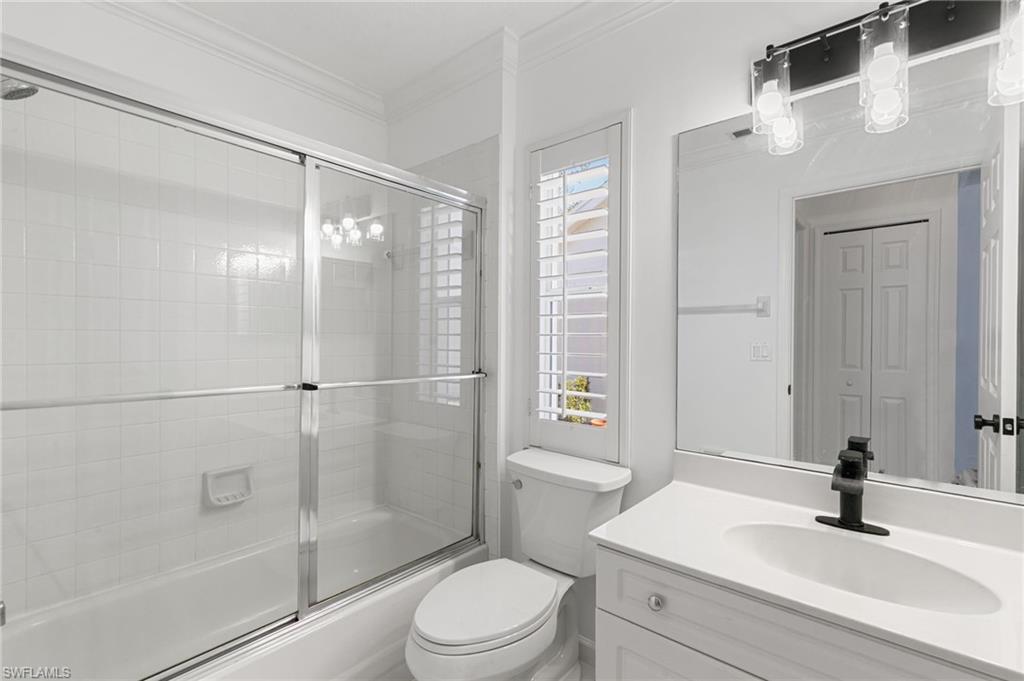 7867 Gardner Drive Naples, FL 34109 - Photo 20 of 36 Bathroom with enclosed tub / shower combo, vanity, and crown molding