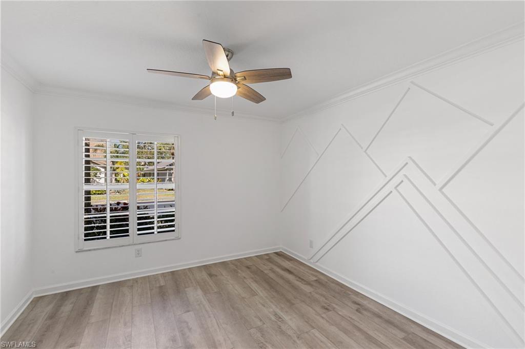 7867 Gardner Drive Naples, FL 34109 - Photo 21 of 36 Spare room with ornamental molding, light wood-style flooring, and ceiling fan